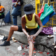 A woman applies skin lightening cream to her legs in downtown Kingston, Jamaica.